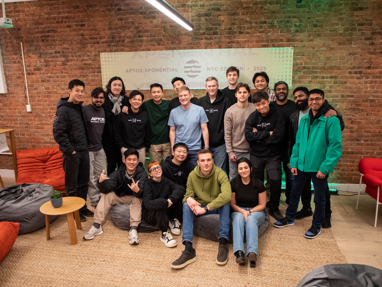 Vin Lim with the founder cohort at Aptos Xponential, NYC Edition 2025, in front of the event banner