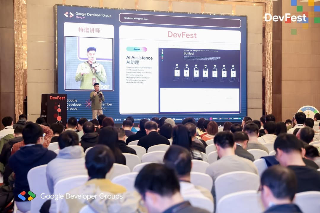 Vin Lim on stage at 2025 Google DevFest Shanghai, in front of a large screen showing his live video beside a slide on AI assistance in Chrome DevTools