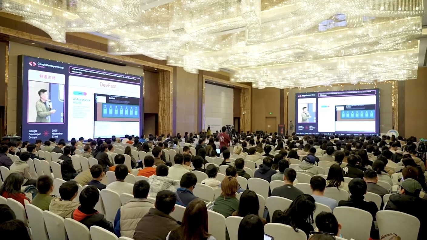 A packed hotel ballroom at 2025 Google DevFest Shanghai, with Vin Lim shown speaking on two large screens beside his slides